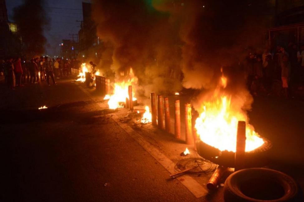 Protesters burned tires in the streets of Guwahati, India, on Wednesday as India's upper house of legislators passed a bill granting citizenship to non-Muslim illegal immigrants.