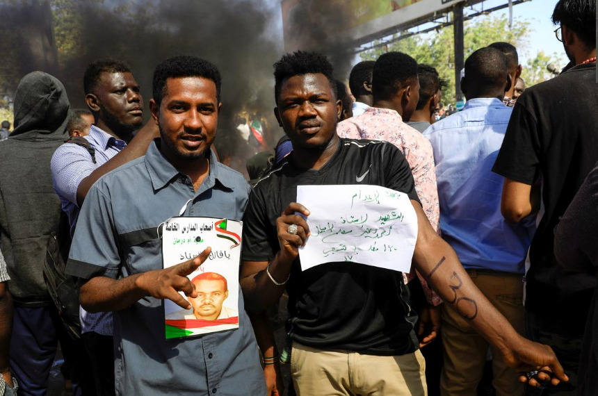 Sudanese civilians gather outside the court during the sentencing of 27 members of the national intelligence service to death by hanging over the killing of a teacher in detention in February during protests that led to the overthrow of former president Omar al-Bashir, in Omdurman, Sudan December 30, 2019.