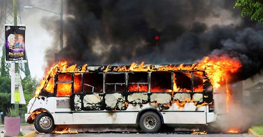 A burning bus, set alight by cartel gunmen to block a road, is pictured during clashes with federal forces following the detention of Ovidio Guzman, son of drug kingpin Joaquin "El Chapo" Guzman, in Culiacan, Sinaloa state,