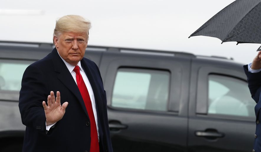 President Donald Trump waves as he exits a motorcade to board Air Force One at Andrews Air Force Base, Md., Saturday, Dec. 14, 2019,