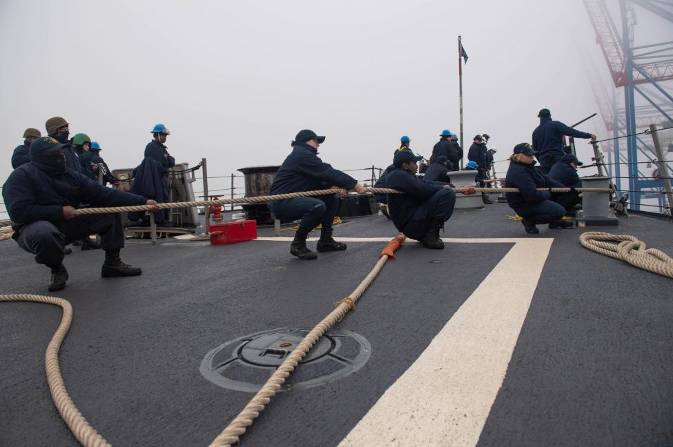 Sailors assigned to the Arleigh Burke-class guided-missile destroyer USS Ross heave in line during a sea and anchor evolution on Dec. 24.