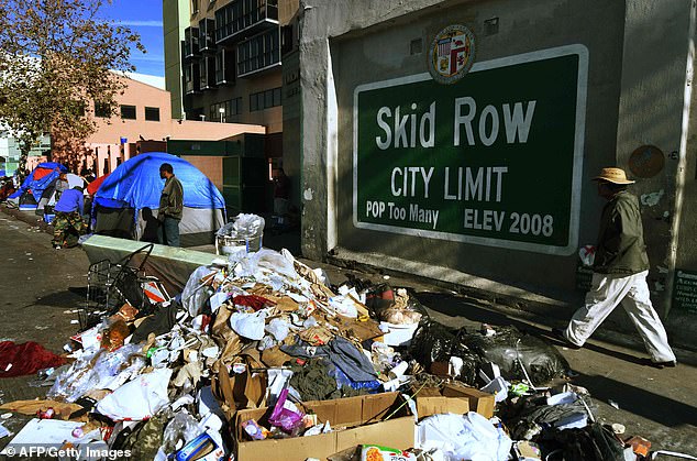 Supporters claim that declaring an emergency would free up state and federal funding reserved for natural disasters, such as earthquakes or wildfires. Trash is seen lining the street of Skid Row, where homeless people have been camping for years .