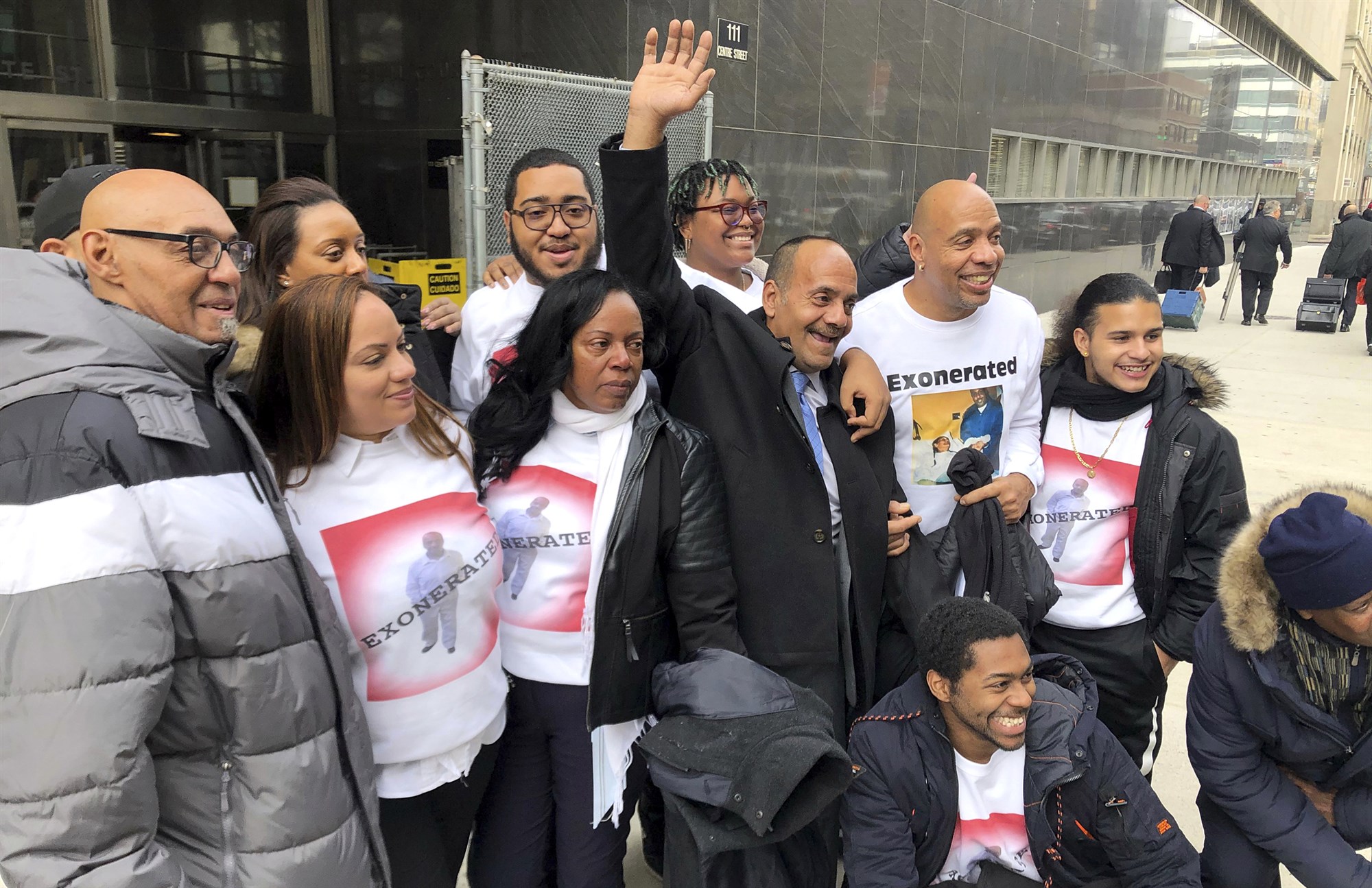 Rafael Ruiz raises his hand outside State Supreme Court in Manhattan after being exonerated of rape on Jan. 28, 2020. 