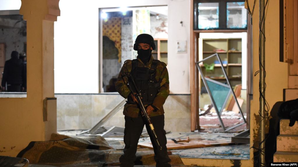 A soldier stands guard at the mosque hit by the bomb blast.