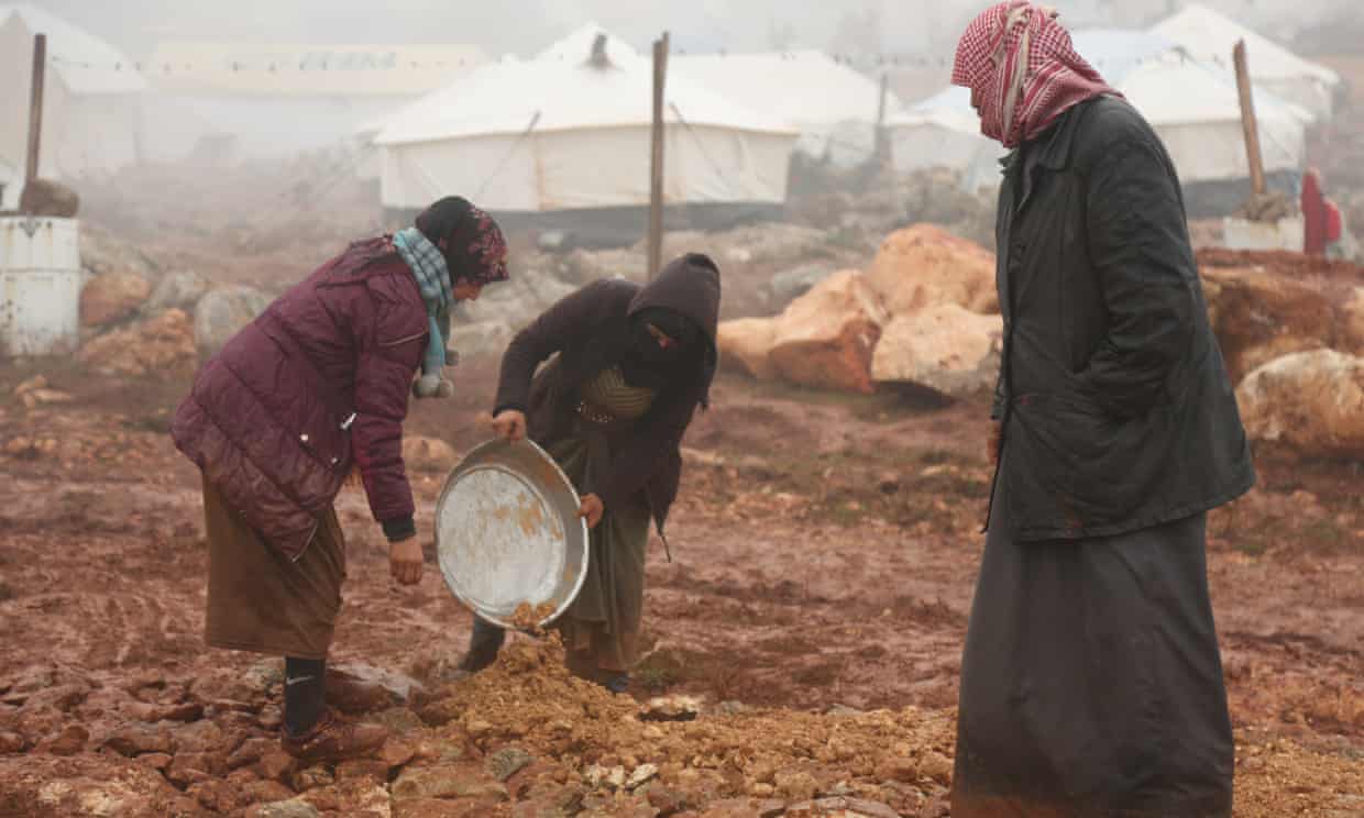 Displaced Syrians clear an area to set up tents after fleeing violence in Maarat al-Numan earlier this month. Photograph: Yahya Nemah/EPA