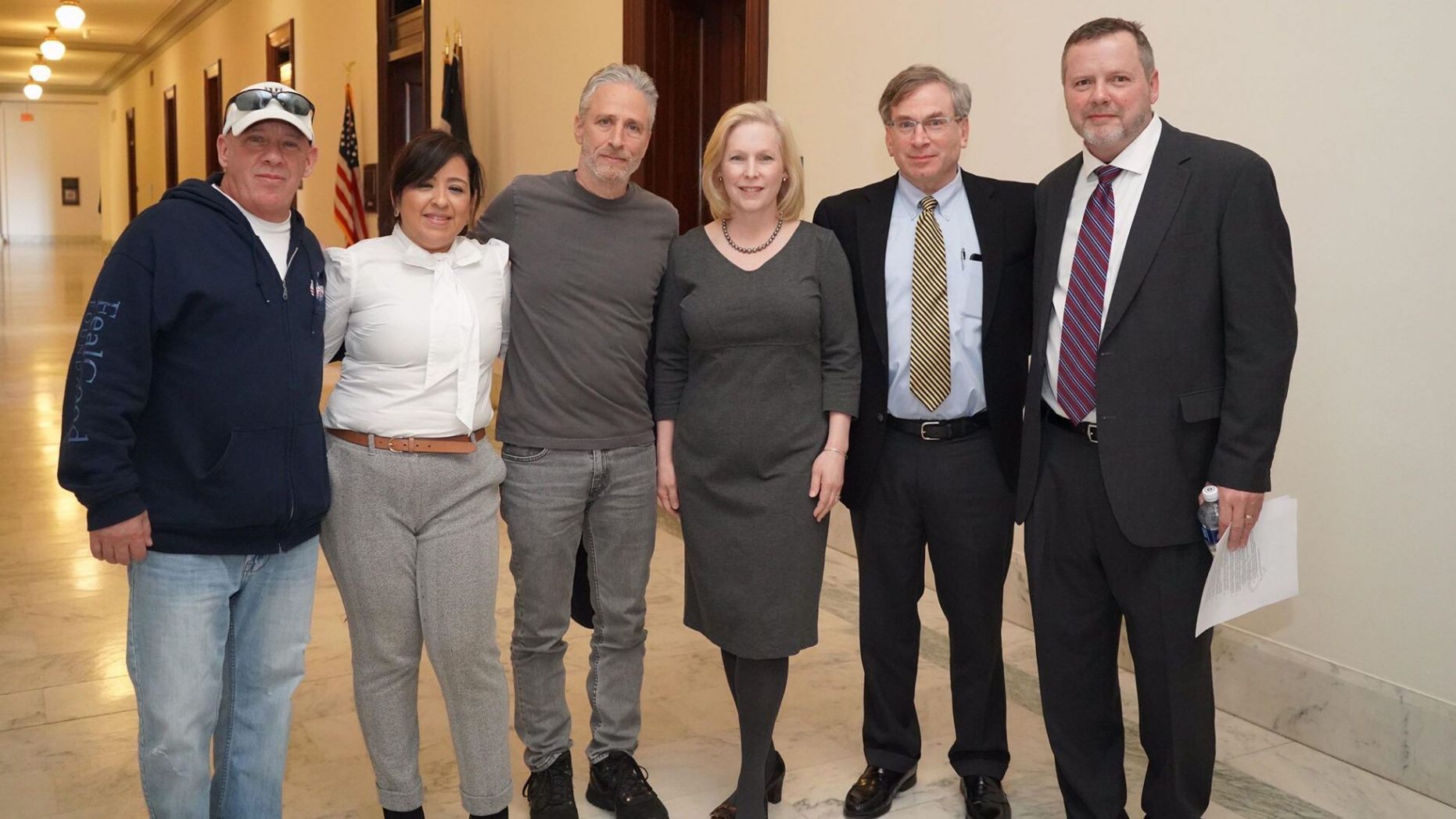 Jon Stewart (center) recently met with Senator Kirsten Gillbrand (D-NY, center) along with advocates John Feal (left) and Rosie Torres (left), founder of Burn Pits 360.
