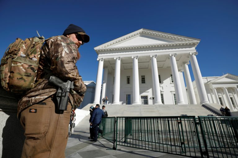 A gun rights activist carries his handgun in a hip holster outside the Virginia State Capitol building as the General Assembly prepares to convene in Richmond, Virginia, U.S. Jan. 8, 2020.