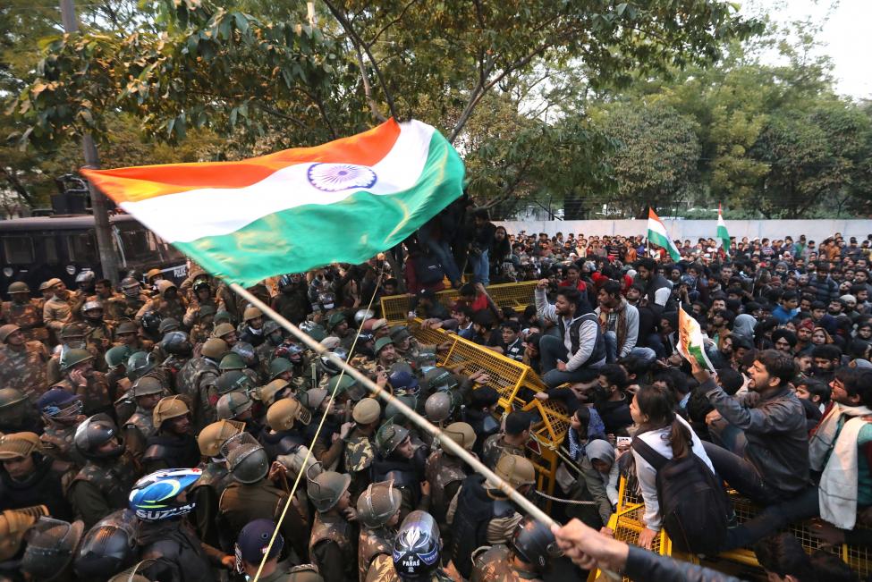 Activists are stopped by Indian security personnel Thursday near Jamia Milia Islamia University in New Delhi, India, 
