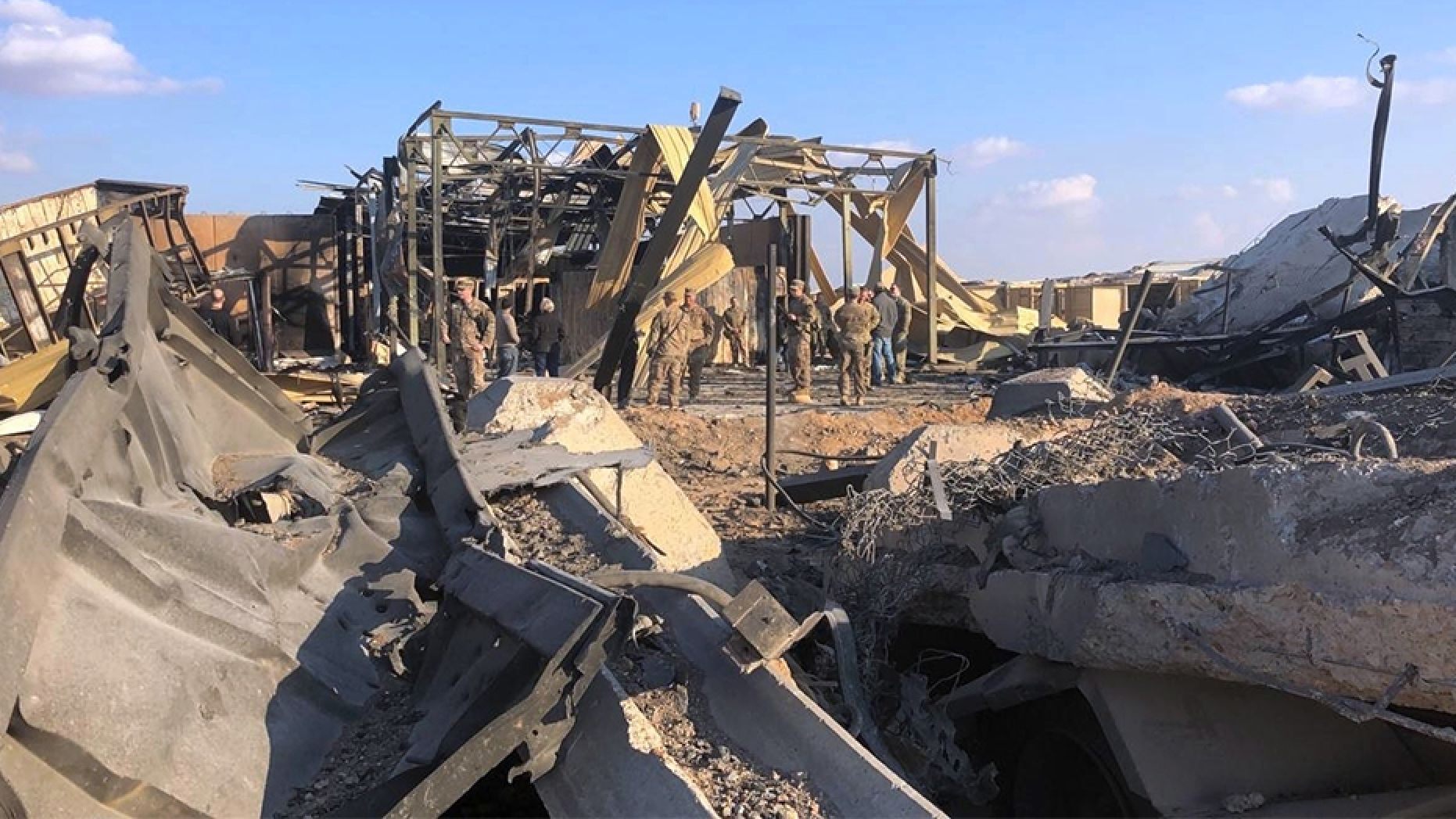 U.S. soldiers and journalists inspect the rubble at a site of Iranian bombing, in Al Assad Air Base, in Anbar, Iraq. (AP)