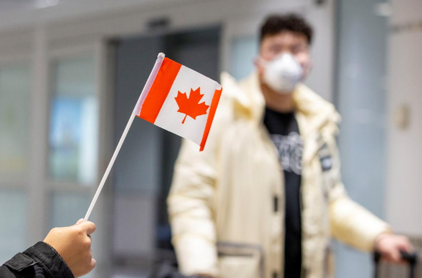 FILE PHOTO: A traveller wears a mask at Pearson airport arrivals, shortly after Toronto Public Health received notification of Canada's first presumptive confirmed case of novel coronavirus, 