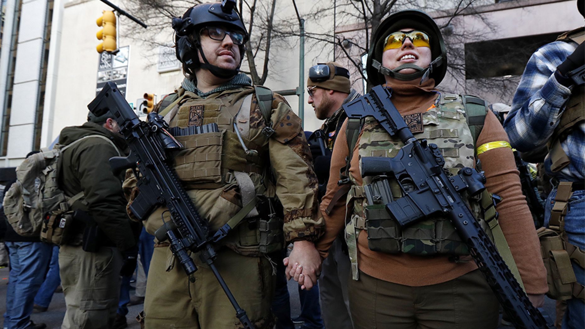 Demonstrators stand outside a security zone before a pro-gun rally in Richmond, Va.