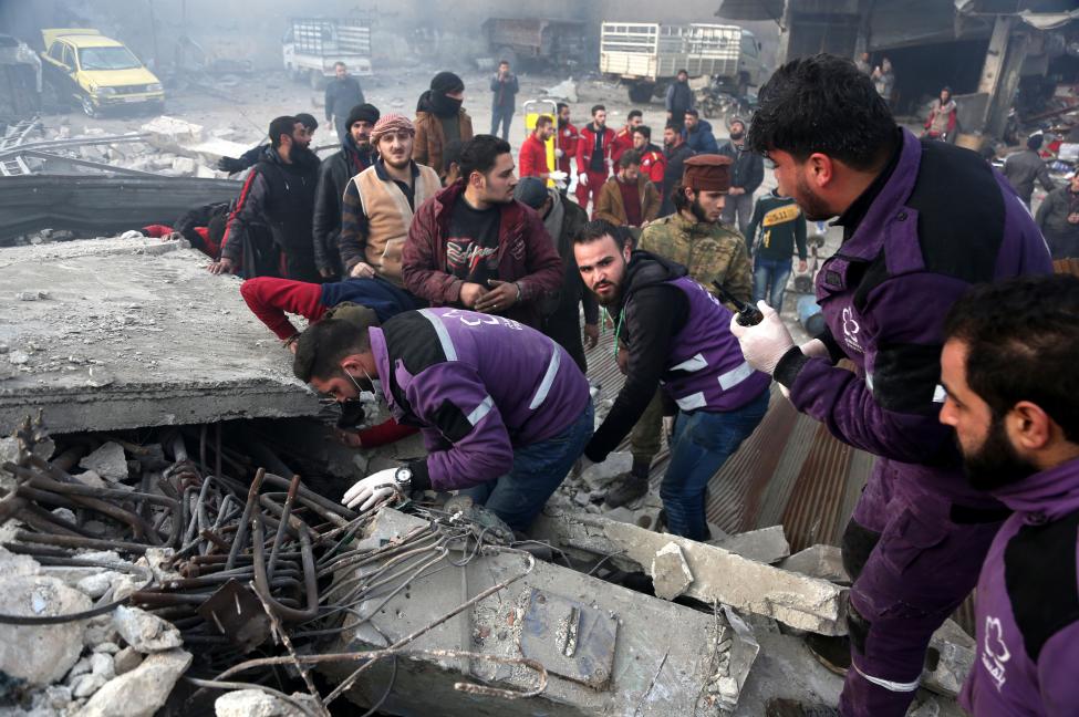 Rescuers search for survivors Wednesday under a collapsed building following an airstrike in Idlib province, Syria. 