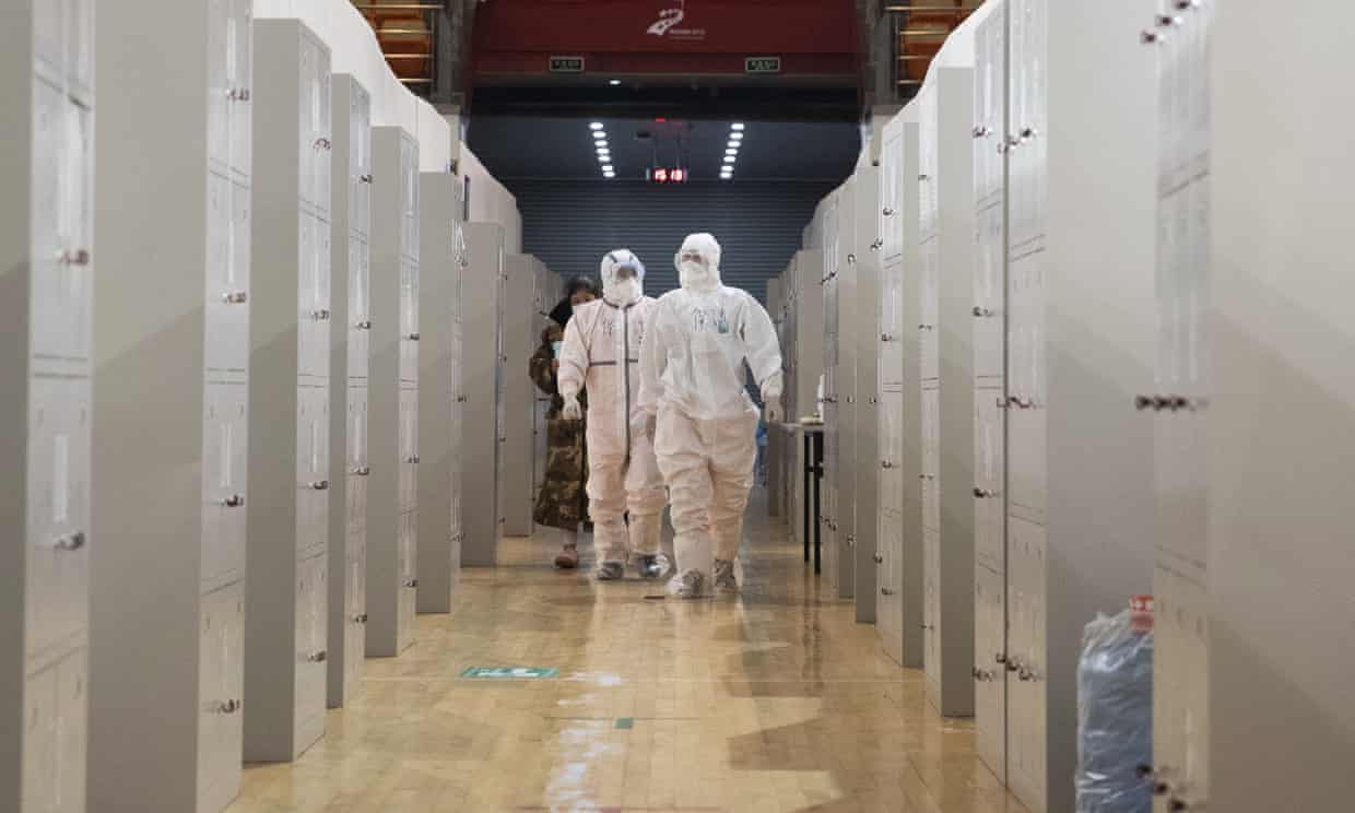 Medical staff carry out checks on patients in Wuhan Fangcang hospital, a makeshift hospital to treat Covid-19 patients. 