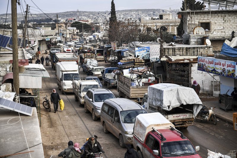 Civilians flee from Idlib toward the north to find safety inside Syria near the border with Turkey, Saturday, Feb. 15, 2020. 