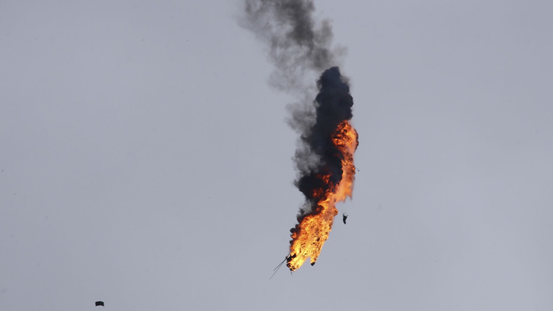 Syrian government helicopter bursts in flames after it was shot by a missile in Idlib province, Syria, Tuesday, Feb. 11, 2020.