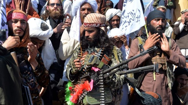 Taliban militants and villagers were pictured celebrating the peace deal on Monday.AFP