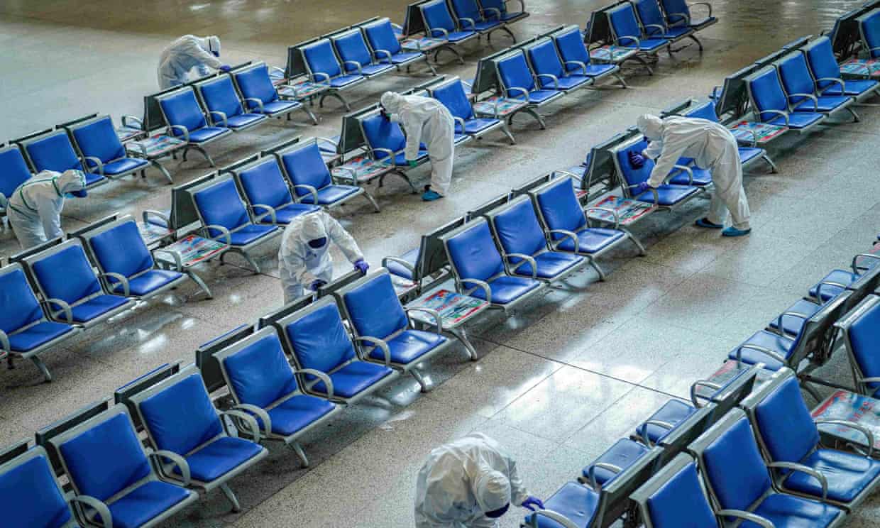 Workers disinfect a waiting area at Wuhan railway station, which has been closed since January. 