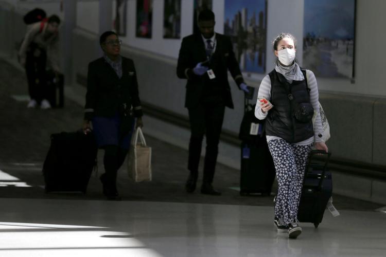 Air passengers leave a customs area March 15, 2020, at Newark Liberty International Airport in Newark, N.J..