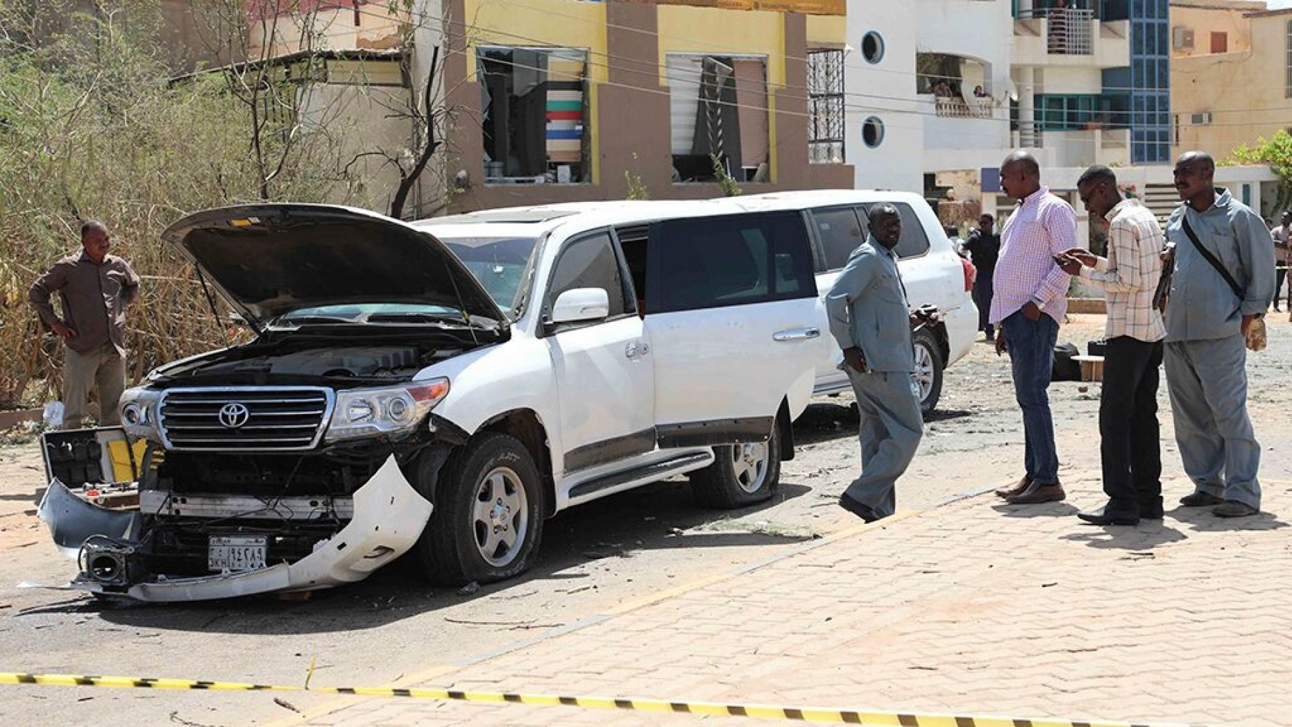 Sudanese policemen stand around vehicles that were part of Prime Mister Abdalla Hamdok's motorcade in Khartoum, Sudan, Monday,