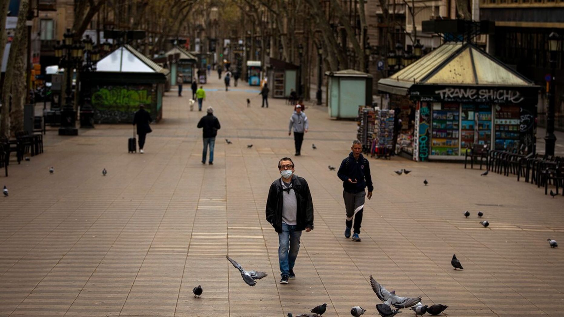People walk along La Ramblas in Barcelona, Spain, Sunday, March 15, 2020.
