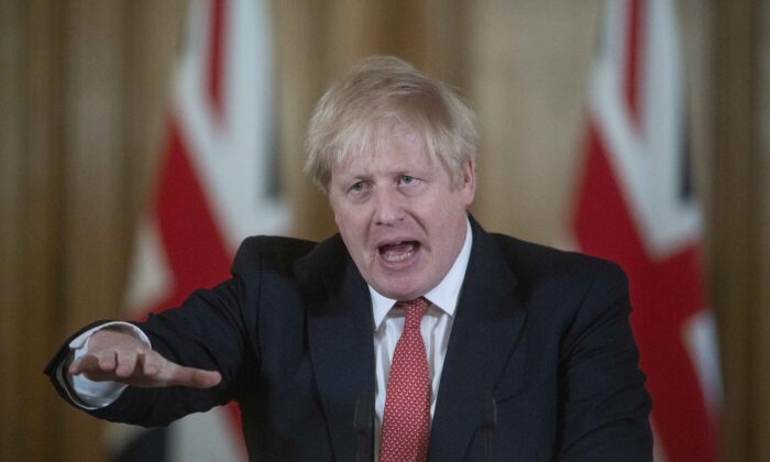 British Prime Minister Boris Johnson gestures as he speaks during a daily press conference at 10 Downing Street on March 20, 2020