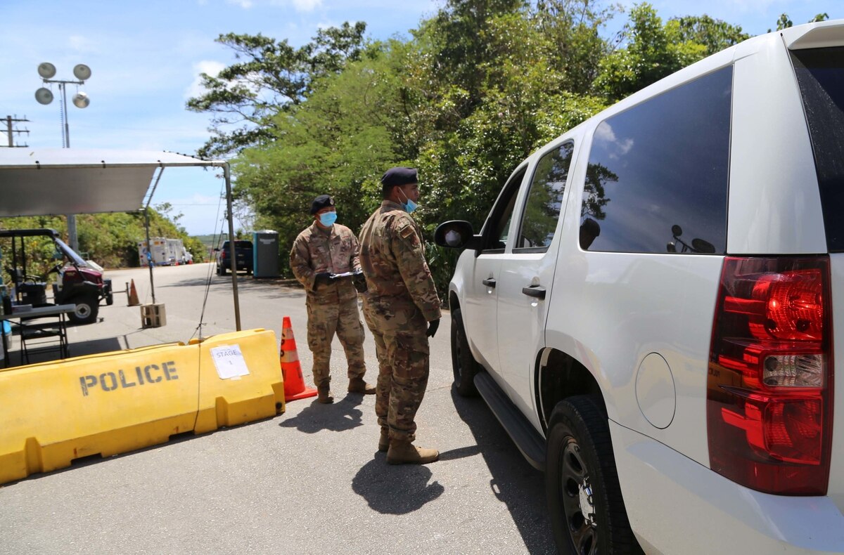 Senior Airman Keith Orlino, left, and Tech. Sgt. Shawn Morrison, right) of the Guam Air National Guard provide security support