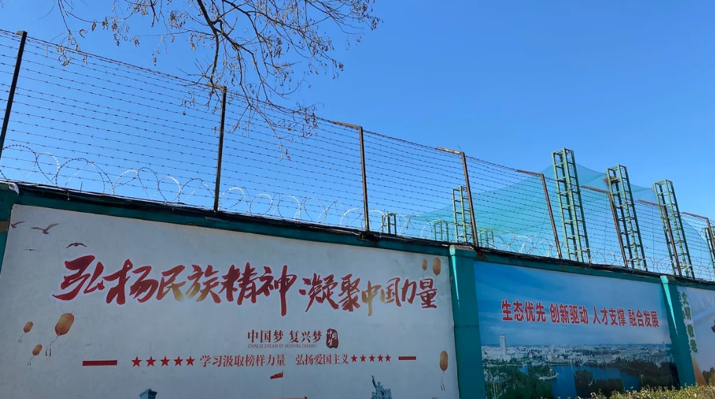 The posters on the wall alongside the Qingdao Taekwang Shoes Co. factory -- the side where the Uighur workers enter and exit, and live in dorms 