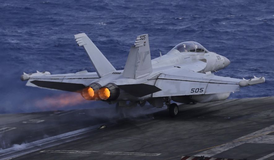An F/A-18 Super Hornet fighter jet takes off on the deck of the U.S. Navy USS Ronald Reagan in the South China Sea, Tuesday, Nov. 20, 2018. 