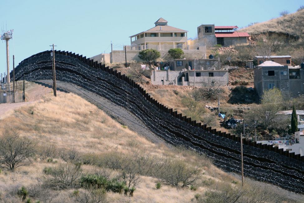 Barbed wire has been placed on top and side of the fence along the United States-Mexico border, shown here, heading East from Nogales, Arizona, in February 2019.