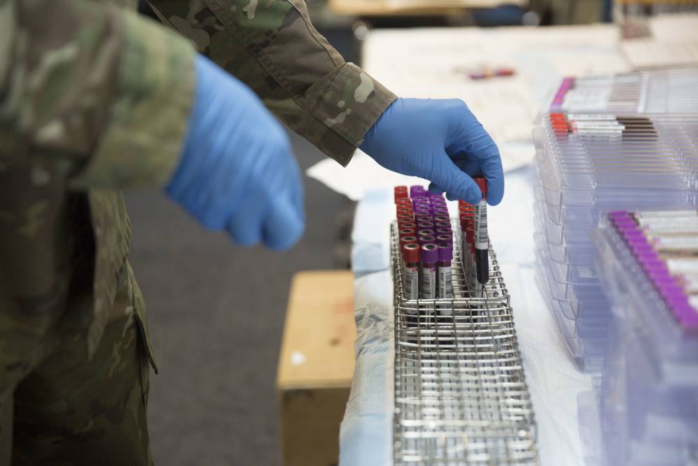 An Army medic sorts through blood samples for prescreening during a Walking Blood Bank training program at Camp Lejeune, N.C.,