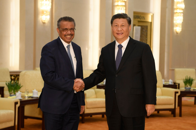 Tedros Adhanom Ghebreyesus (left), the director-general of the World Health Organization, shakes hands with Chinese President Xi Jinping