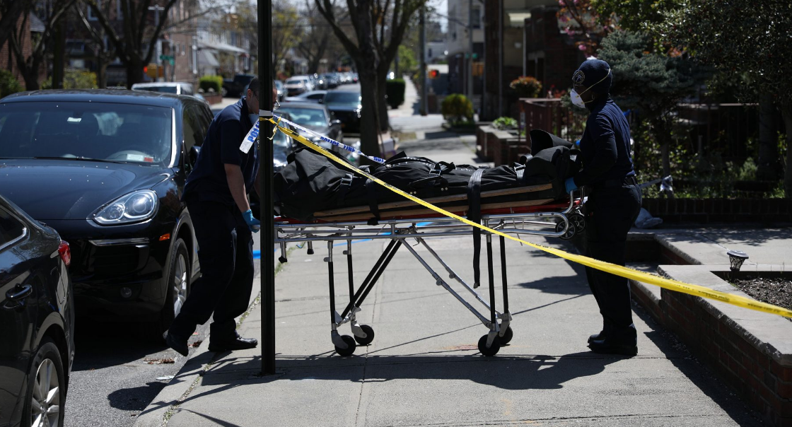 The body of Imad "Albert" Ahmad, 57, is carried out by employees of the Medical Examiner Wednesday morning.