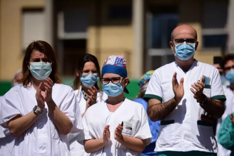 Health workers wearing protective gear applaud during a flash mob at the Pavullo hospital near Modena in Italy on April 9, 2020.