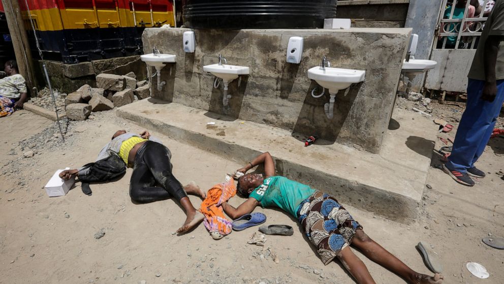 Two women who were injured after being trampled lay on the ground, 