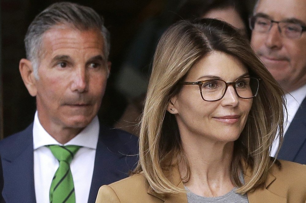 FILE - In this April 3, 2019, file photo, actress Lori Loughlin, front, and her husband, clothing designer Mossimo Giannulli, left, 