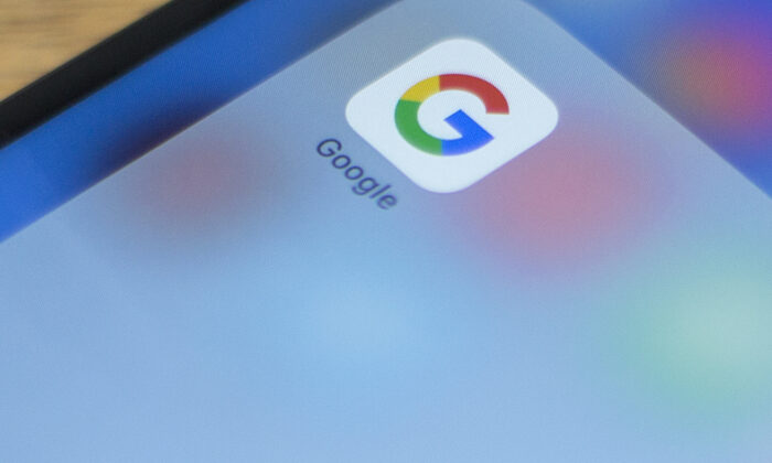 Google's logo on a phone in this photo illustration on July 10, 2019. (Alastaire Pike/AFP via Getty Images)