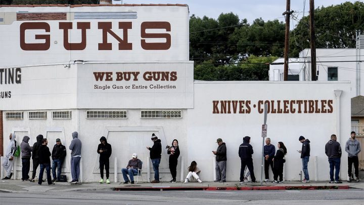 People wait in line to enter a gun store in Culver City, Calif., March 15, 2020.