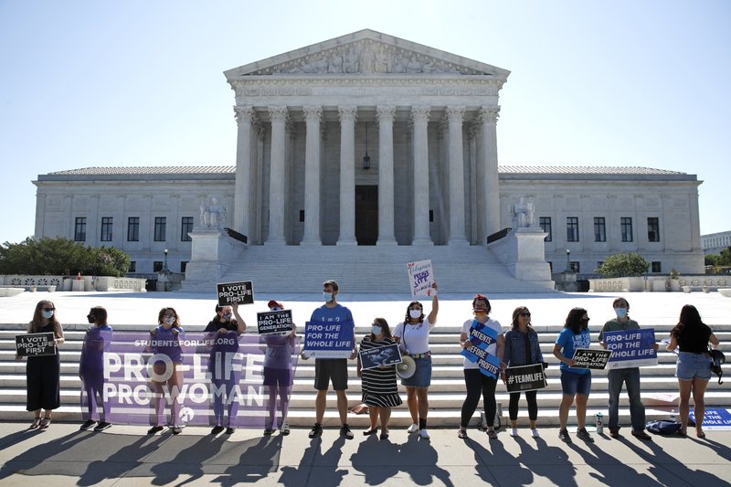 Anti-abortion protesters wait outside the Supreme Court for a decision, Monday, June 29, 2020,