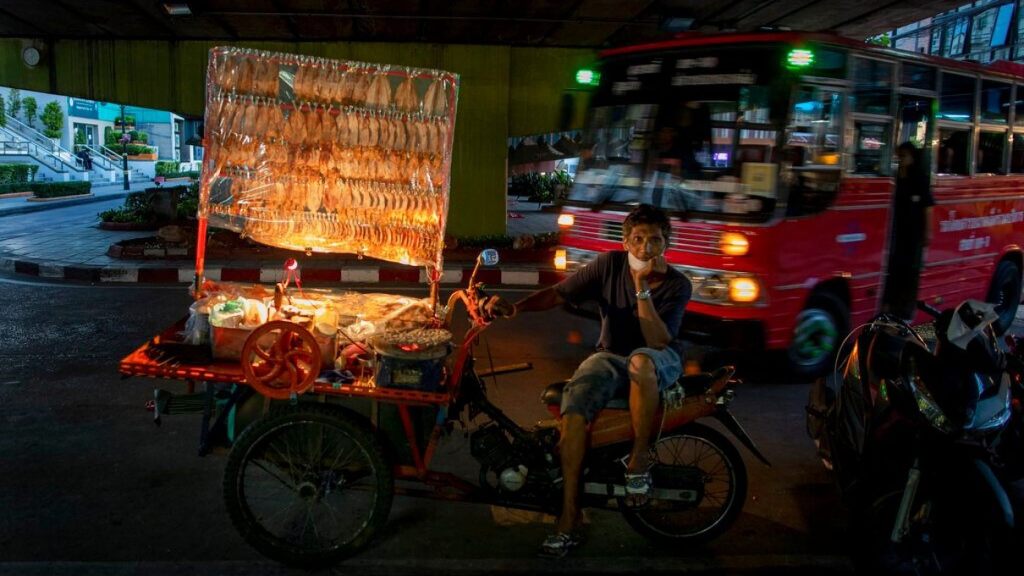A mobile food vender looks for customers in Bangkok, Thailand, Tuesday, June 9, 2020.  (AP)
