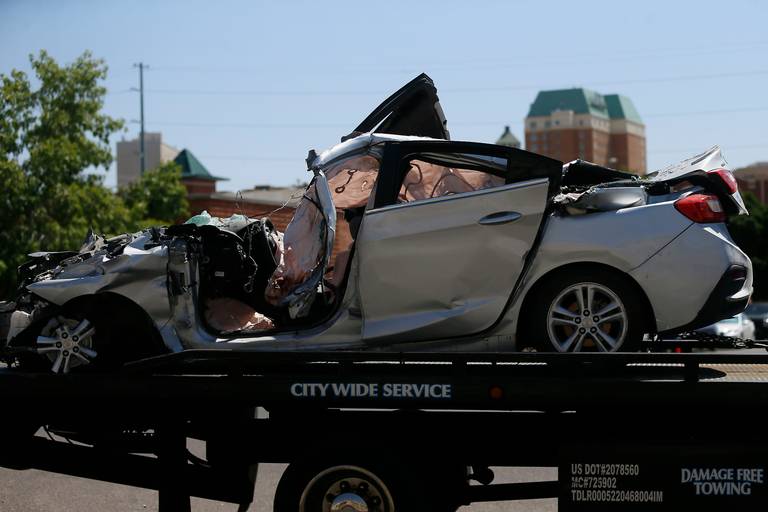 A damaged silver four-door vehicle is transported after being involved in a crash involving 10 people Thursday, June 25, 2020, in El Paso, Texas. 