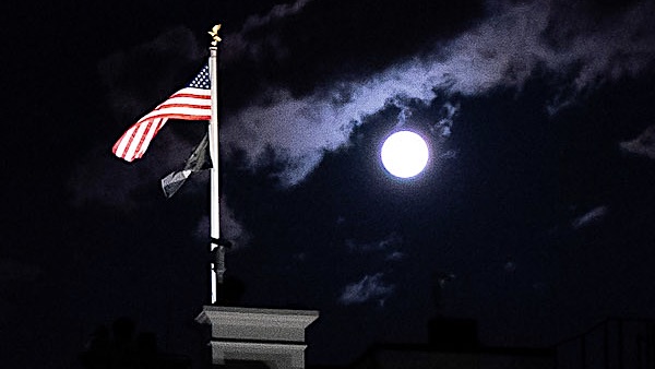 The Full Pink Moon, the largest full moon of 2020, rises above the North Portico of the White House Tuesday, April 7, 2020, in Washington, D.C. 