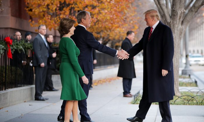 Former first lady Laura Bush and former President George W. Bush greet President Donald Trump outside of Blair House in Washington on Dec. 4, 2018.