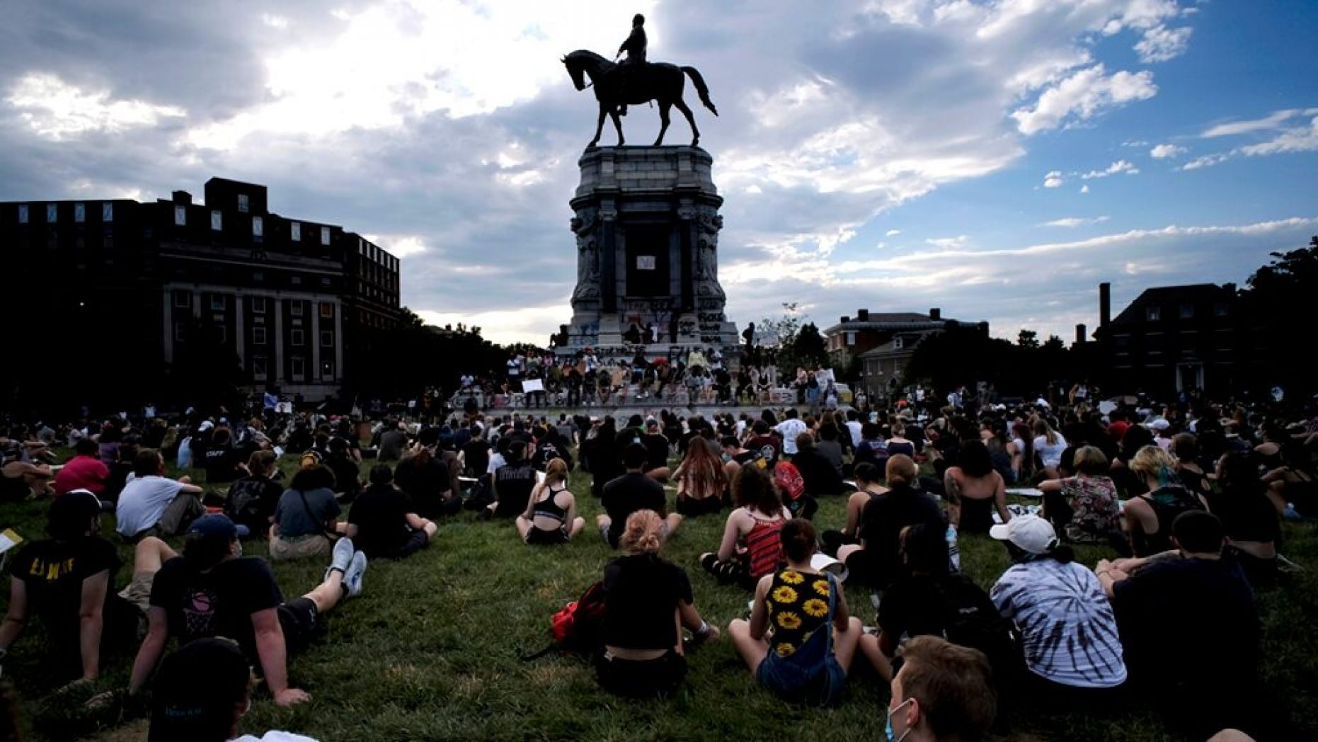 Protesters sit near the statue of Robert E. Lee on Monument Avenue in Richmond, Va., Wednesday, June 3, 2020. 
