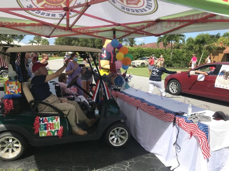 Thompson waves to passersby Tuesday morning.