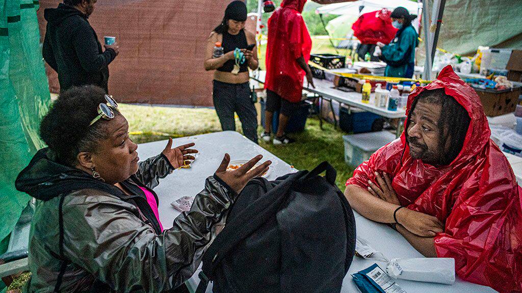 Park & Recreation Board Commissioner Londel French, right, who has been spending a lot of time at Powderhorn Park making sure that the encampment is a safe ,