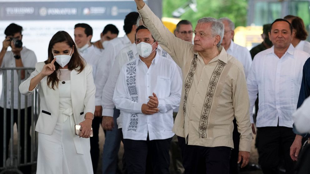Mexican President Andres Manuel Lopez Obrador waves to supporters in Lazaro Cardenas, Quintana Roo state, Mexico, Monday, June 1, 2020.