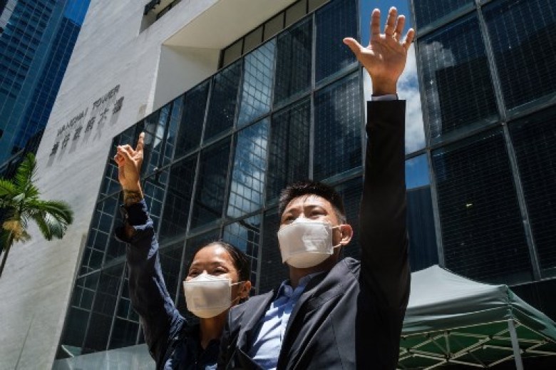 Elaine To (L), 41, and Henry Tong, 39, celebrate outside the District Court in Hong Kong after the couple were found not guilty of rioting during the widespread pro-democracy protests in 2019.