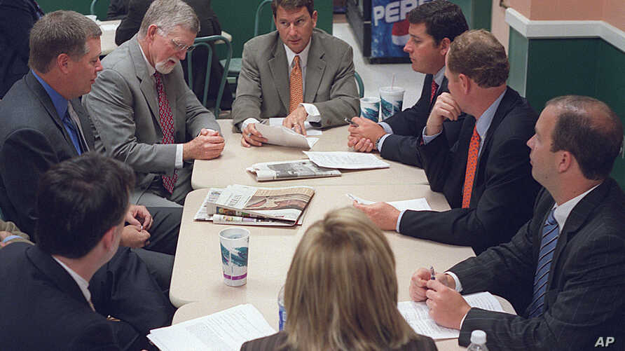 FILE - Lobbyist Brian Ballard, center meets with other lobbyists. Ballard has collected more than $2.3 million in lobbying fees this year.