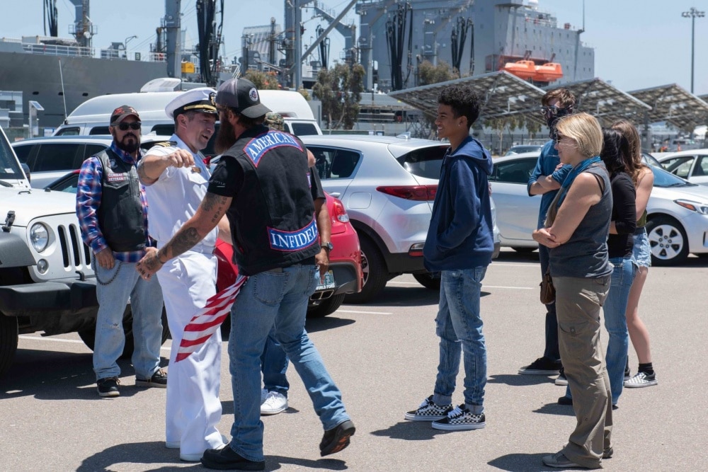 U.S. Navy Lt. Cmdr. Zachary Macdonald reunites with his family at Naval Air Station North Island July 9, 2020.