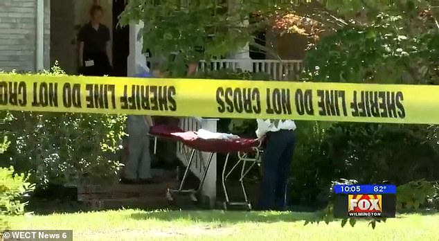 Medics are seen wheeling a gurney into Adams' home on Thursday after deputies discovered his dead body